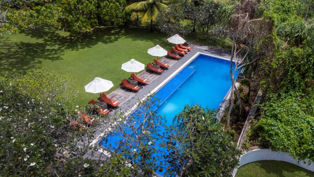Boutique heritage hotel Club Villa Bentota featuring Geoffrey Bawa's tropical modernism architecture and lush garden landscape